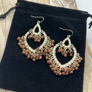 Dangle Gold tone heart earrings with Crystals and small wooden beads .